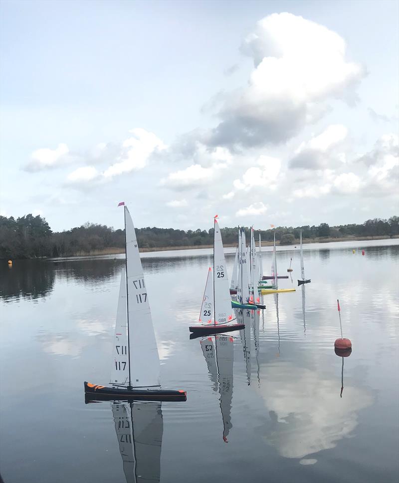 10 Rater Tankard at Frensham - a good lineup at the start, but hardly any movement and wind indicators pointing in different directions, but the efficiency of these boats still provided a good performance when a gust arrived photo copyright John Haine taken at Frensham Pond Sailing Club and featuring the 10 Rater class