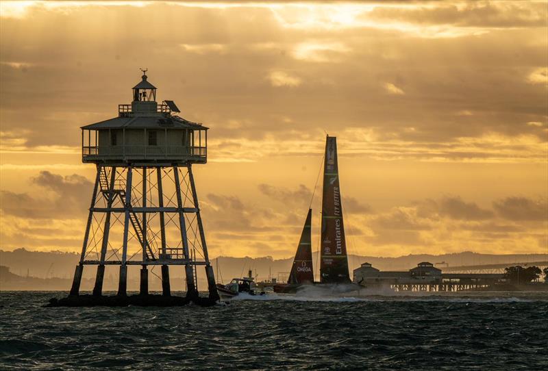 Emirates Team NZ passes the iconic Bean Rock and heads into the sunset photo copyright Emirates Team New Zealand taken at Royal New Zealand Yacht Squadron and featuring the AC75 class