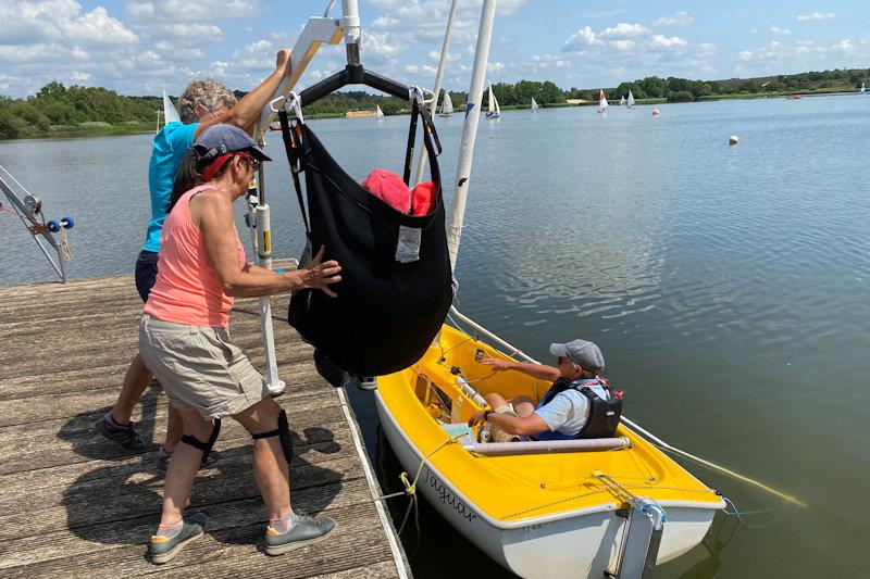 Hoist process step 3 - the wheelchair can be backed away, and the hoist rotates to move the sailor over the boat moored alongside - photo © Magnus Smith