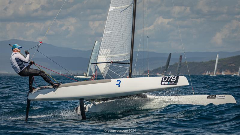 Sopot legend Jacek Noetzel, POL 1, now sailing in the Classic fleet, could be in a very good place should the winds come good, seen here doing his famous Pufferfish impression as he gets things wound it up - photo © Gordon Upton / www.guppypix.com