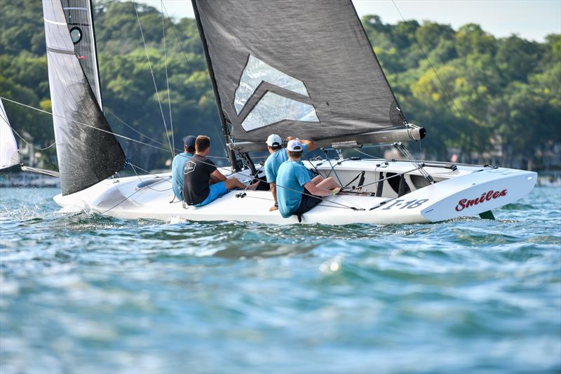 Harry Melges IV, second from back, checks the compass while working downwind photo copyright Doug Wake/Vakaros taken at  and featuring the A Scow class