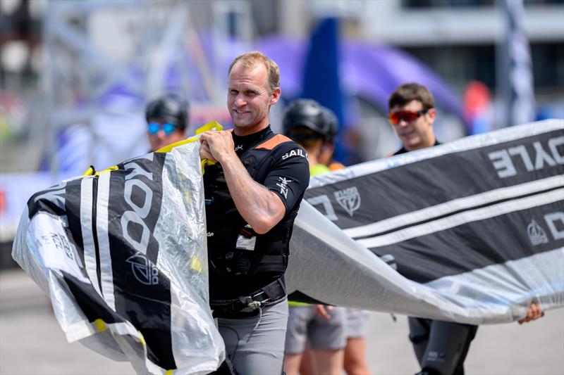 Josh Junior, grinder of New Zealand SailGP Team, carries the teams Doyle Sails across the Technical Base ahead of the Great Britain Sail Grand Prix | Plymouth in Plymouth, England. 28th July 2022 photo copyright Jon Buckle/SailGP taken at Royal Plymouth Corinthian Yacht Club and featuring the F50 class