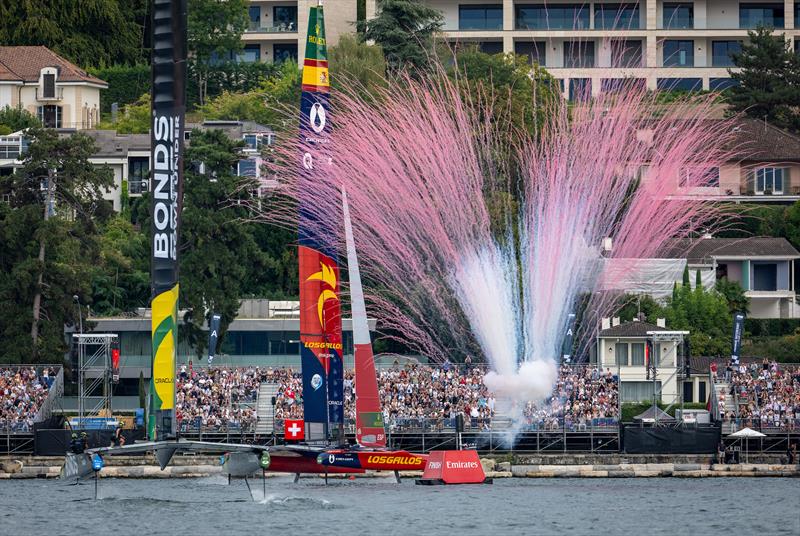 Pyrotechnics are released in front of the grandstand as Los Gallos SailGP Team driven by Diego Botin cross the finish line to win the final race ahead of BONDS Flying Roos SailGP Team on Race Day 2 of the Switzerland Sail Grand Prix in Geneva, Switzerland - photo © Jonathan Nackstrand for SailGP