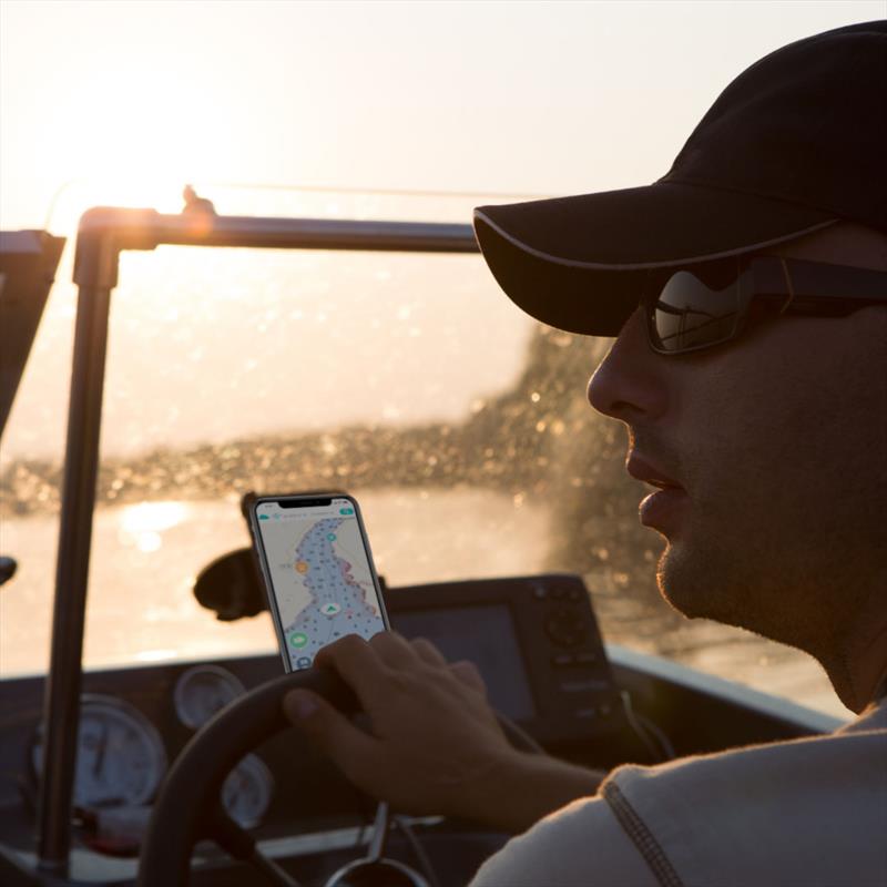 Boater using Wavve Boating to navigate at dusk down a channel photo copyright Wavve Boating taken at  and featuring the Fishing boat class