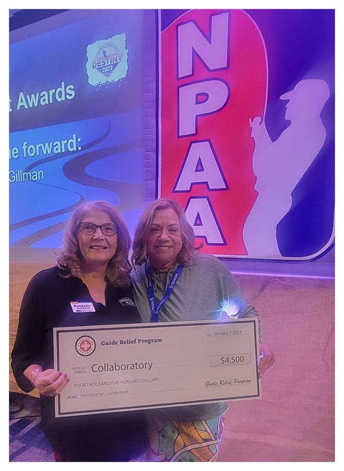 Check in hand, Barbara Alderson, Campaign Manager for United Way of Lee County, Florida (left), and Mollie Simpkins, Co-Founder & Executive Director of the Guide Relief Program - photo © National Professional Anglers Association