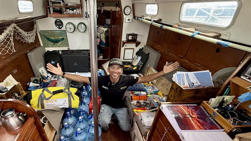 Canadian skipper Isa Rosli is all smiles after passing his GGR safety inspection aboard the OE 32 Olleanna. Every piece of mandatory equipment is still spread throughout the cabin—one major milestone completed, with the final packing still to come - photo © JJ / GGR2026