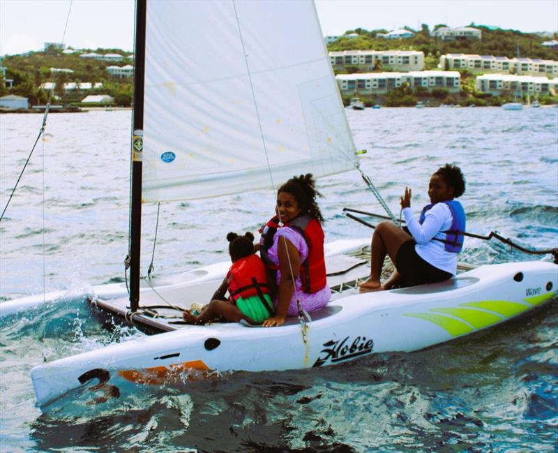 Leah Williams (right) gives mother, Cinnamon DeMarco (center) and a sibling a sail on a Hobie Wave - photo © STSC / C. Bareuther