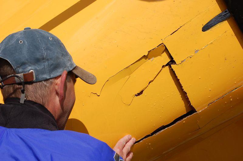 In the days before carbon fibre, tortured ply offered boat builders a relatively inexpensive route to a stiff, lightweight hull... but it doesn't withstand impact very well, such as a tumbling helm following a cartwheel capsize! - photo © David Henshall