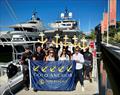 The Boat Works team being presented their flag