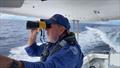 A Marine Rescue Shoalhaven volunteer searches waters off Port Kembla