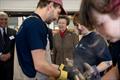 HRH The Princess Royal and Lord-Lieutenant of Dorset, Professor Michael Dooley watch a demonstration of steam bending at the Boat Building Academy in Lyme Regis