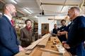 HRH The Princess Royal was given a tour of the Boat Building Academy in Lyme Regis by Director Will Reed (left) and met past and present students