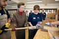 HRH The Princess Royal assists students of the Boat Building Academy during a demonstration of steam bending