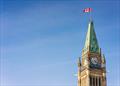 A Canadian flag flying on the top of the Peace Tower, part of the Canadian Parliament Building in Ottawa