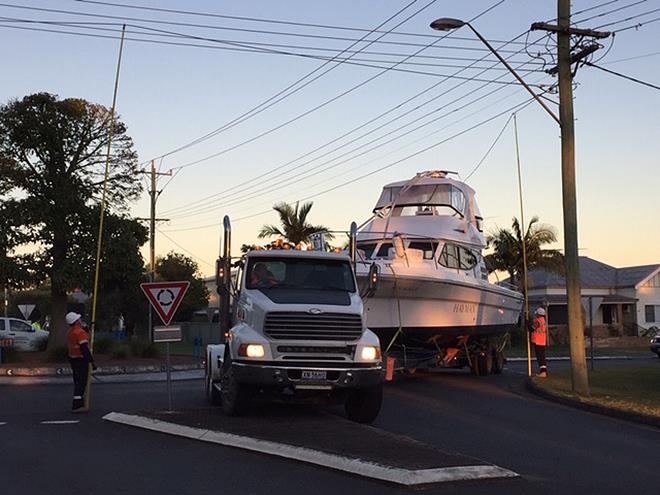 Essential Energy staff lifting power lines to assist early morning transfer for the 6.5m high vessel from Steber's factory to the Manning River photo copyright John Bulmer taken at  and featuring the Marine Industry class