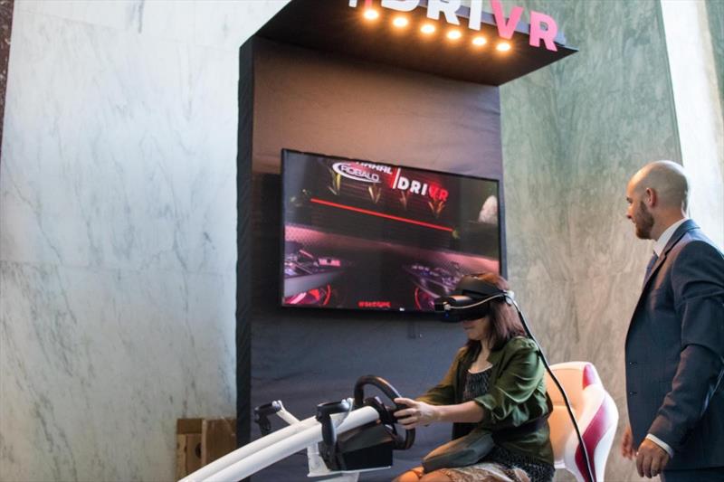 Chaparral Boats' Ryan Swaims (right) instructs a guest through the //DRIVR virtual reality boat display. - photo © National Marine Manufacturers Association