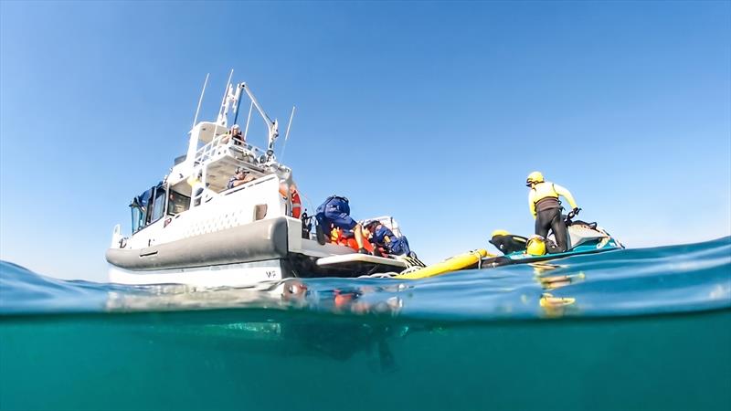 A Marine Rescue NSW rescue watercraft operator transfers a manikin to the rescue vessel - photo © Marine Rescue NSW
