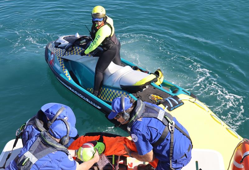 A Marine Rescue NSW rescue watercraft operator transfers a manikin to the rescue vessel - photo © Marine Rescue NSW
