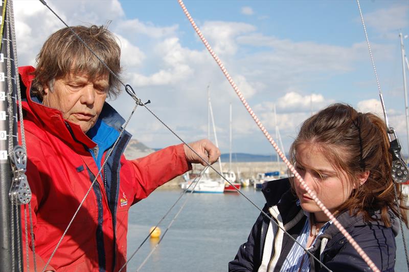 Jon Turner may not have had the easiest entry into dinghy racing, but the natural teacher in him is clearly evident. At Lyme Regis, he is schooling crew Kate into the finer arts of crewing and sometimes complex systems used in a state of the art Merlin photo copyright Henshall taken at Lyme Regis Sailing Club and featuring the Merlin Rocket class