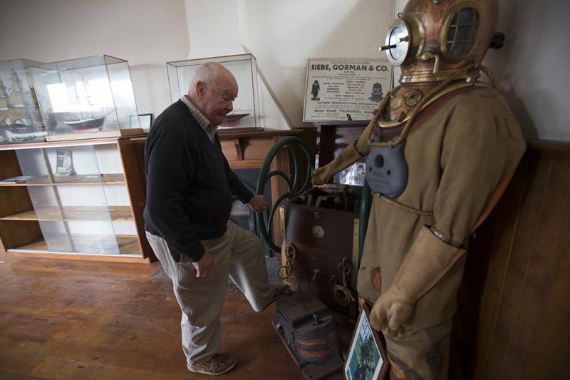 John Street looks over a deep sea diving suit used in a lot of salvage and other underwater tasks - photo © NZ Maritime Museum