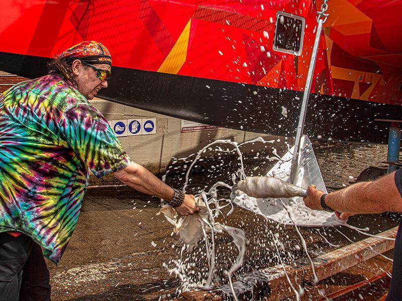 The new owner of `Vingilote` breaks the ceremonial bottle of champagne just prior to the launch of the boat photo copyright Balance Catamarans taken at 