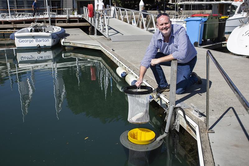 Commodore Paul Billingham with one of the newly installed SeaBins located in the CYCA Marina photo copyright Cruising Yacht Club of Australia taken at Cruising Yacht Club of Australia