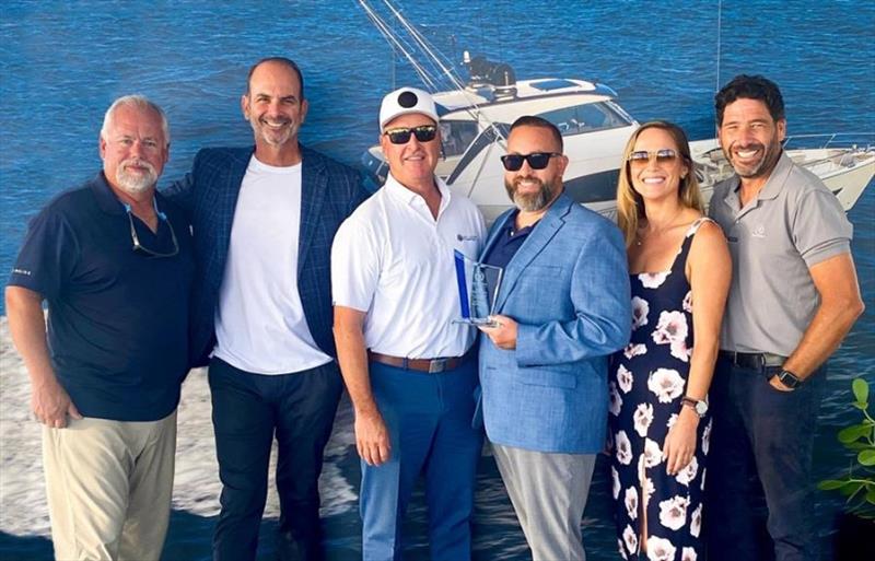 The Sun Country Marine team accepts the Sales Excellence from a Dealership Award for 2021. (from left) Riviera's Rob Scott, with Sun Country Marine's JR Wills, John Painter, Jeremiah Parkinson and Taylor Basso and Riviera's Chris McCafferty. - photo © Riviera Australia