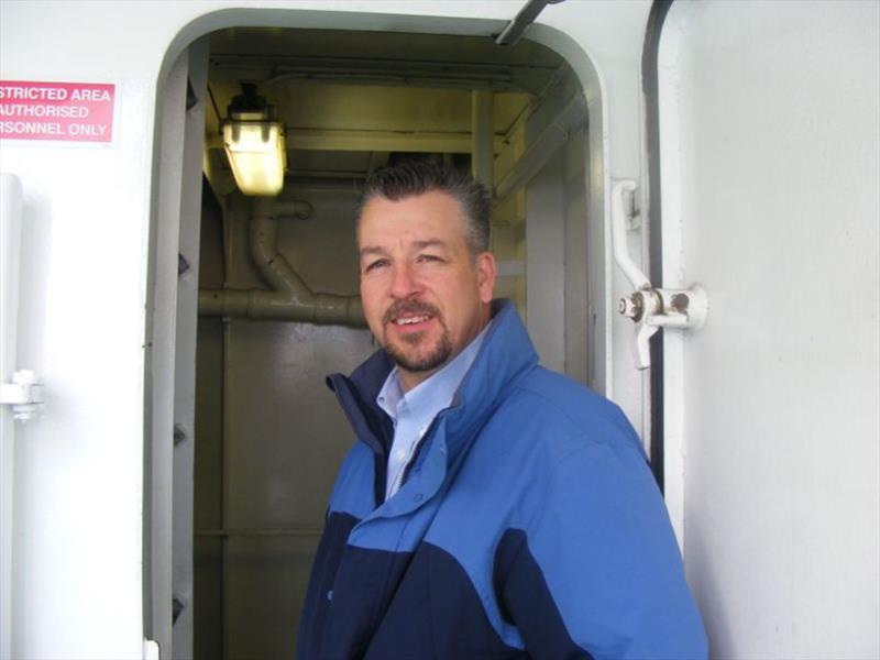 While visiting Sweden, Chris Chenette enters a vessel to review an IMO III solution. - photo © Caterpillar Marine