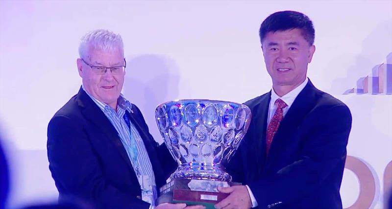 David Tillett AM receives the Trophy from World Sailing President Quanhai Li - photo © Australian Sailing