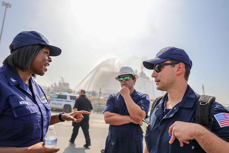 Coast Guard Capt. Zeita Merchant, Captain of the Port of New York and New Jersey, and members of Coast Guard Sector New York discuss the response to the fire in the Port of Newark on July 6, 2023. Marine firefighting specialists can be seen in the backgro - photo © Coast Guard Foundation