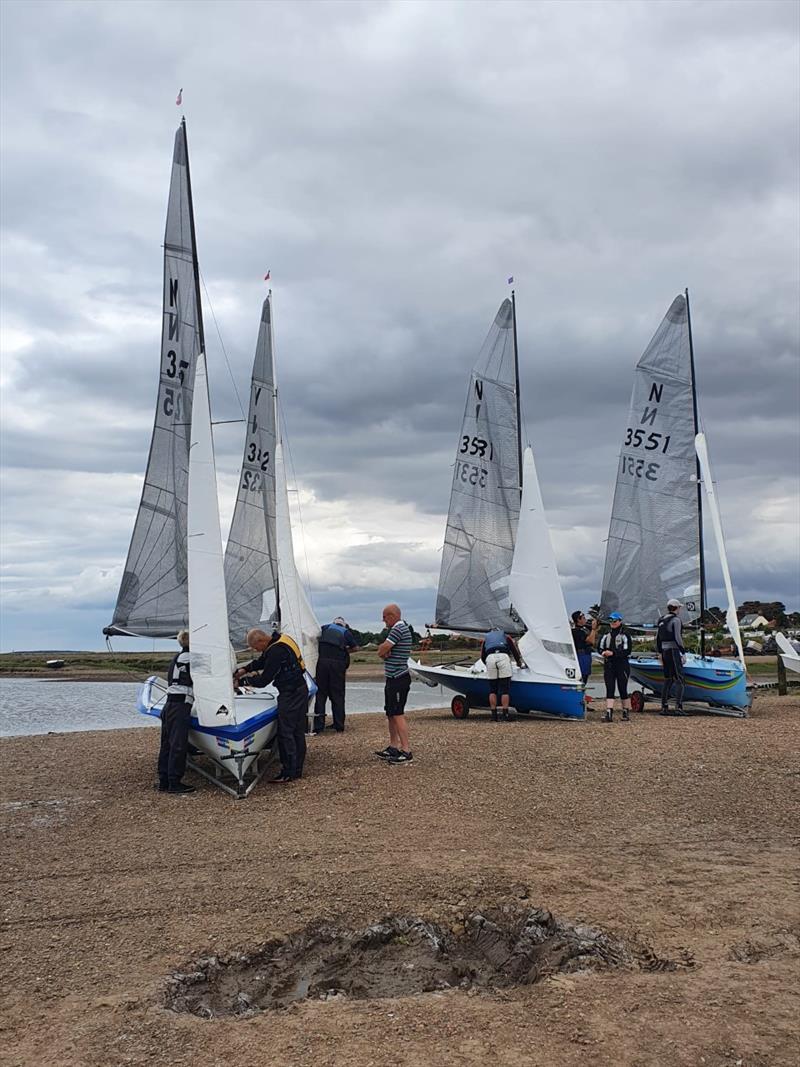 National 12s at North West Norfolk Week 2022 - launching at Brancaster photo copyright Rosie Gore taken at Brancaster Staithe Sailing Club and featuring the National 12 class