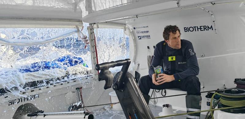 The Ocean Race Leg 1 onboard Biotherm: Paul Meilhat during lunch with the waves hitting - photo © Minghao Zhangh / Biotherm