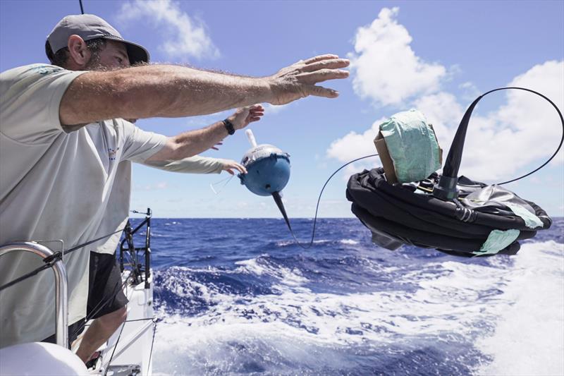 05 February 2023, Onboard 11th Hour Racing Team during Leg 2, Day 12. Simon Fisher and Jack Bouttell release the drogue and drifter buoy into the South Atlantic Ocean - photo © Amory Ross / 11th Hour Racing / The Ocean Race