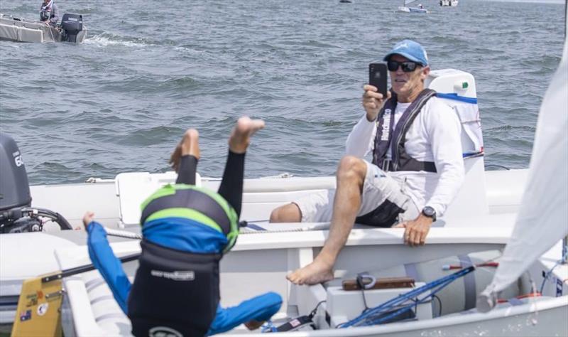 Joel Beashel does a flip into the water to celebrate winning the Australian Optimist Championship, as his father, Adam, watches on (and films it) photo copyright Photo supplied taken at Royal Yacht Club of Victoria and featuring the Optimist class