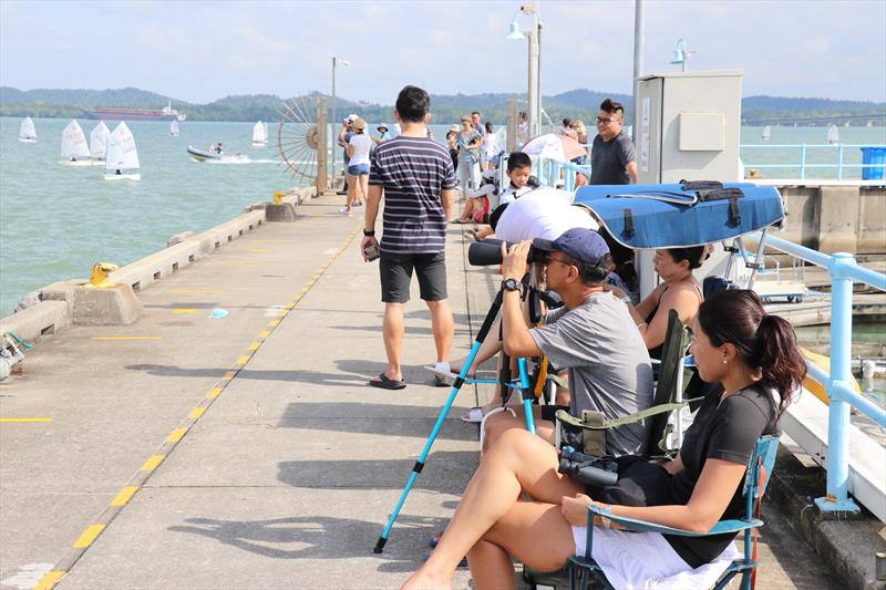 Parents braved the heat along the breakwater to watch their children race - Raffles Marina Optimist Regatta 2022 - photo © Raffles Marina