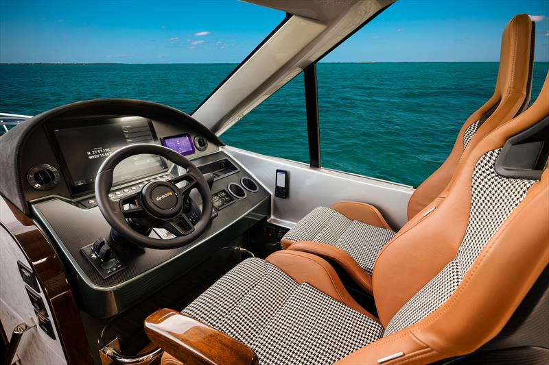 Drawing inspiration from high-performance automotive design, the interior incorporates contemporary carbon fiber accents and beautiful Alcantara fabric finishes - photo © Palm Beach Motor Yachts
