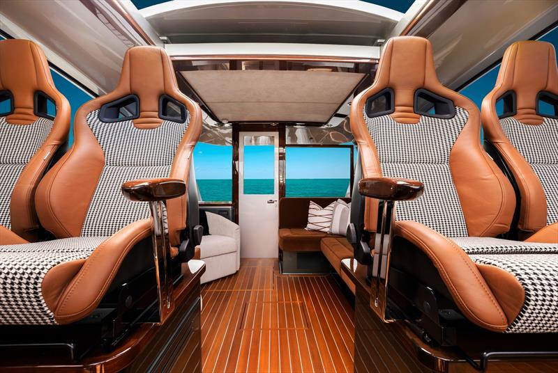 Drawing inspiration from high-performance automotive design, the interior incorporates contemporary carbon fiber accents and beautiful Alcantara fabric finishes - photo © Palm Beach Motor Yachts
