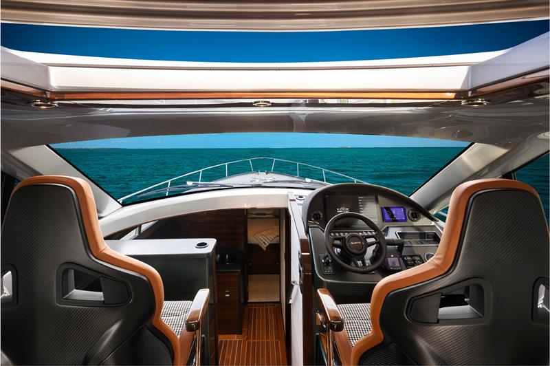 Contemporary carbon fiber detailing is incorporated throughout the interior complemented by Palm Beach Motor Yacht's signature high-gloss teak joinery and handcrafted finish work - photo © Palm Beach Motor Yachts