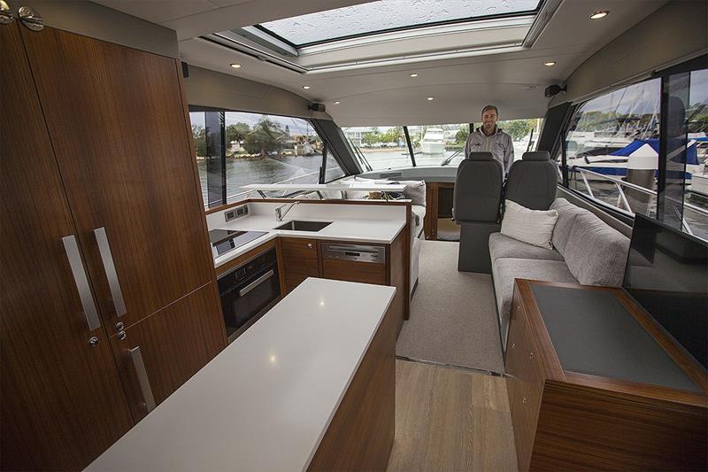 Main Saloon is spacious, light and airy with the huge Vista Windows and opening sunroof adding to it all. Galley will whip up a feast in no time, too! - photo © John Curnow