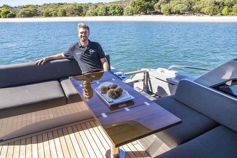 Tom Barry-Cotter in the versatile cockpit with the offset table that can be set for dining table or coffee. - photo © John Curnow