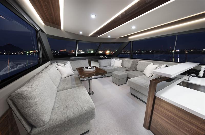 Main Saloon of the new Maritimo M55 - not the cool dining table with angled ends to ensure total walk around capabilities - photo © Maritimo