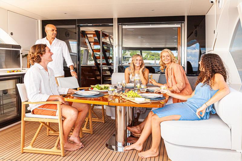 The saloon deck extends to the transom, offering plush lounges, a dining space and comprehensive barbecue unit. - photo © Riviera Australia