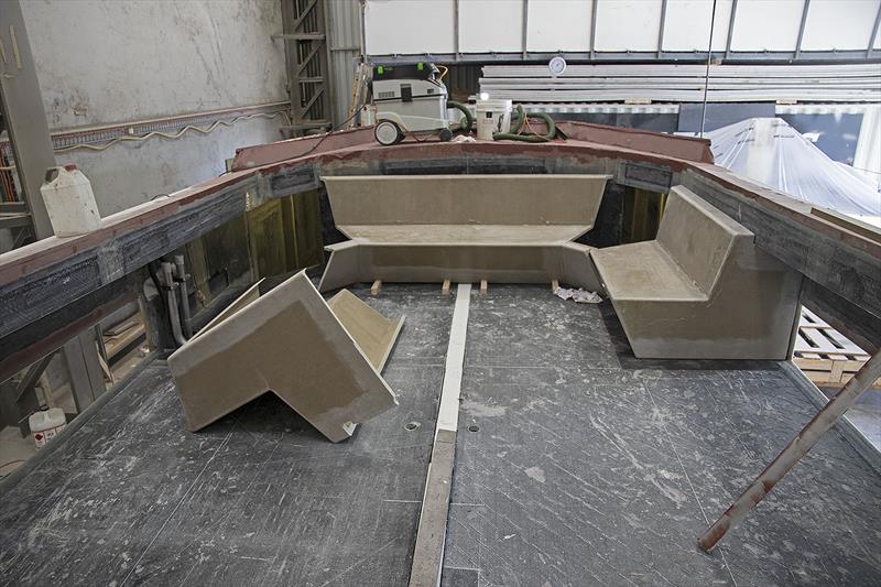 Seating up for'ard under the protective glass, with a cooler in the centre under the table. Three helm chairs across, roughly where the white line is on the deck. BBQ, Fridge and ice maker behind them. - photo © John Curnow