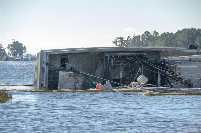 An overturned fishing trawler lays on her side while TowBoatUS and the US Coast Guard oversee salvage operations. BoatUS Foundation NOAA Grant to remove derelict vessels and fishing nets from Beaufort Harbor in Beaufort, North Carolina - photo © BoatUS Foundation