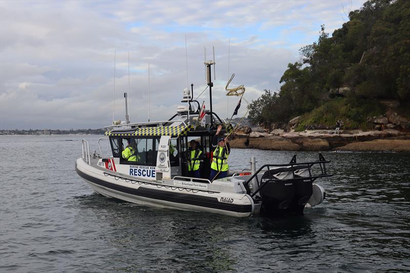 A volunteer crew on board Port Jackson 31 throws a line to a boater in distress - photo © Marine Rescue NSW